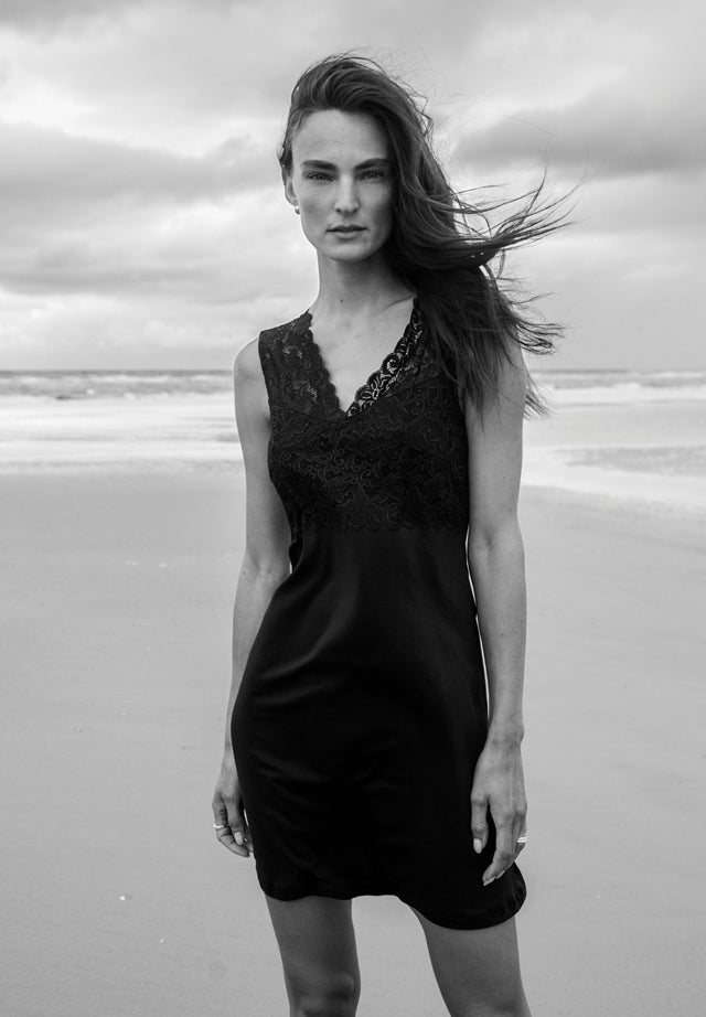 Women posing on the beach with hair blowing in the wind, wearing Moments Tank Gown in Black