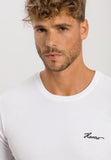 Man wearing a white t-shirt with branding on a light gray background