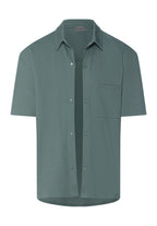 Green short-sleeve shirt on a white background