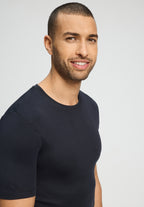 Man wearing a black t-shirt against a plain background