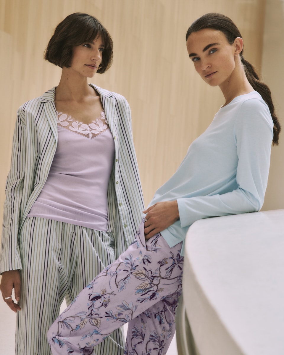 Two women wearing Sleep & Lounge pajama sets and Kalea Camisole in a casual setting.
