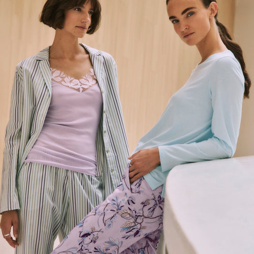 Two women wearing Sleep & Lounge pajama sets and Kalea Camisole in a casual setting.