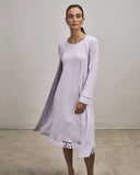 Woman wearing a Kalea light purple nightgown with a matching robe against a plain background