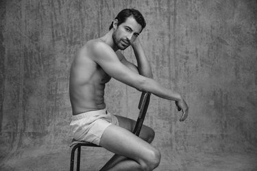 Man posing on chair wearing Fancy Woven Boxers