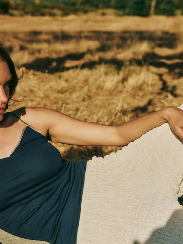 Woman laying in field wearing Style Icon Cotton Seamless Camisole 