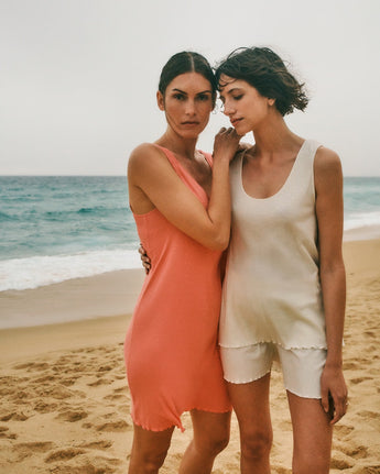 Two woman models. One is wearing Serena Cotton and Linen Pajama Set. The other is wearing Serena Cotton and Linen Nightgown.