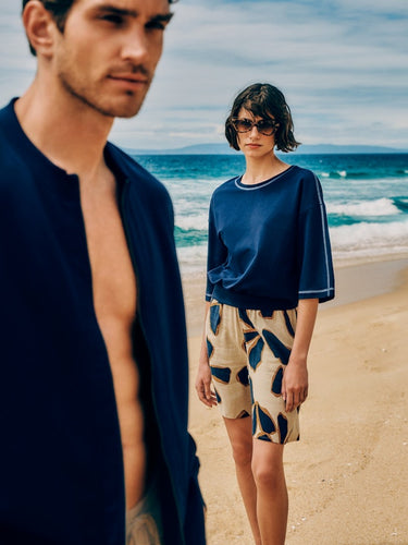 Man and Women standing on beach wearing  Natural Living paired with Urban Casual Shorts 