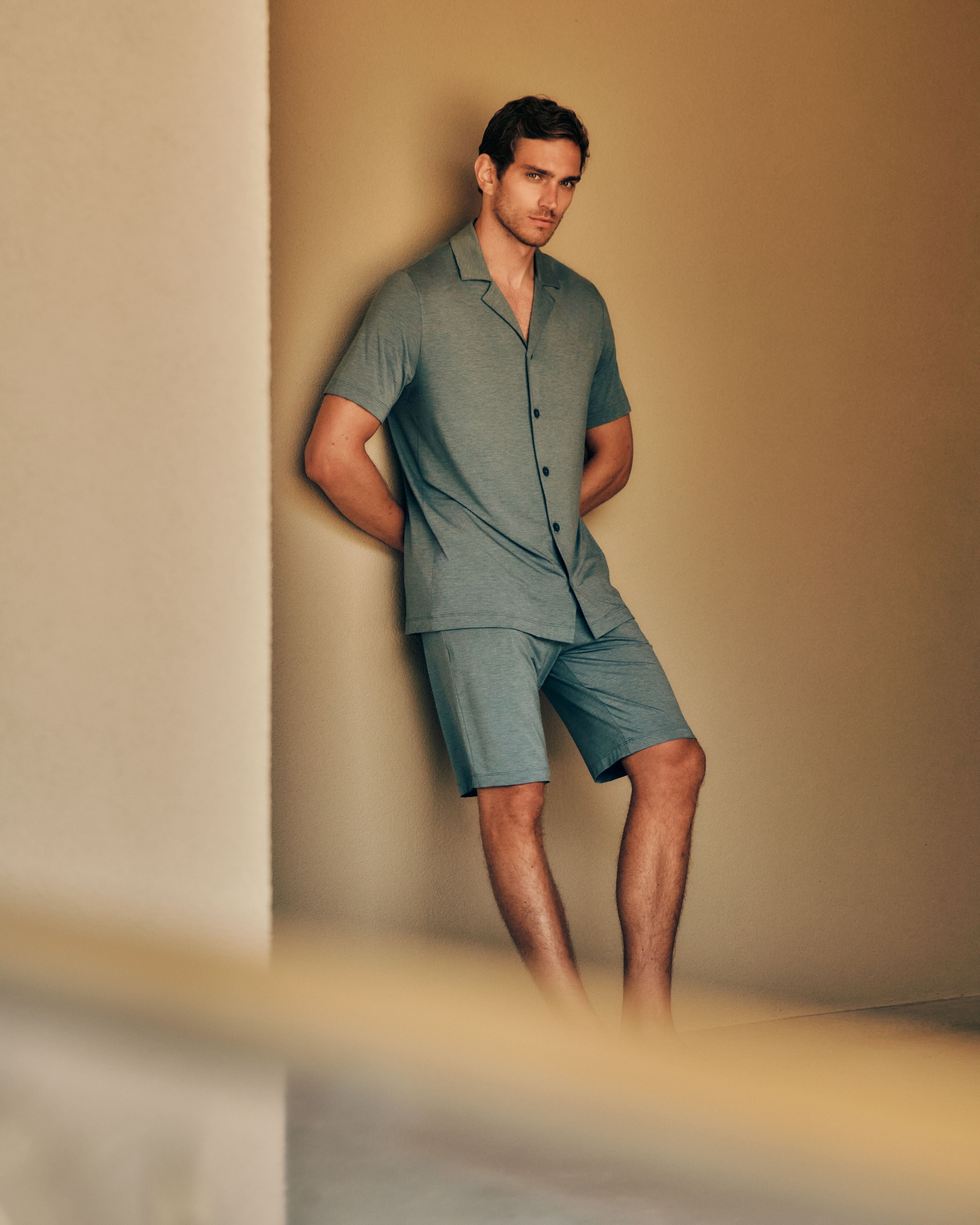 Man leaning against wall wearing Casuals Shirt and short set