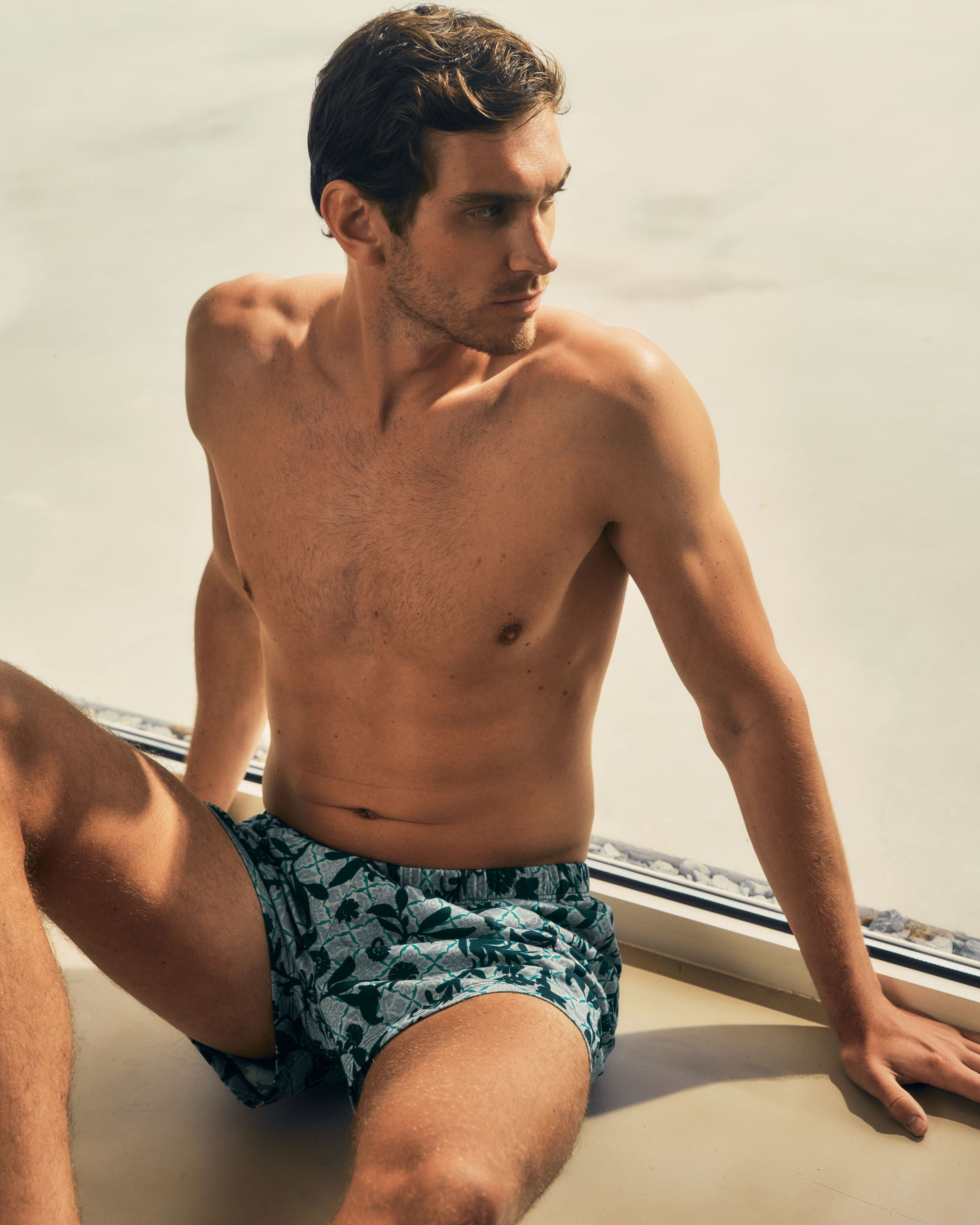 Man sitting down wearing Cotton Sporty printed boxers