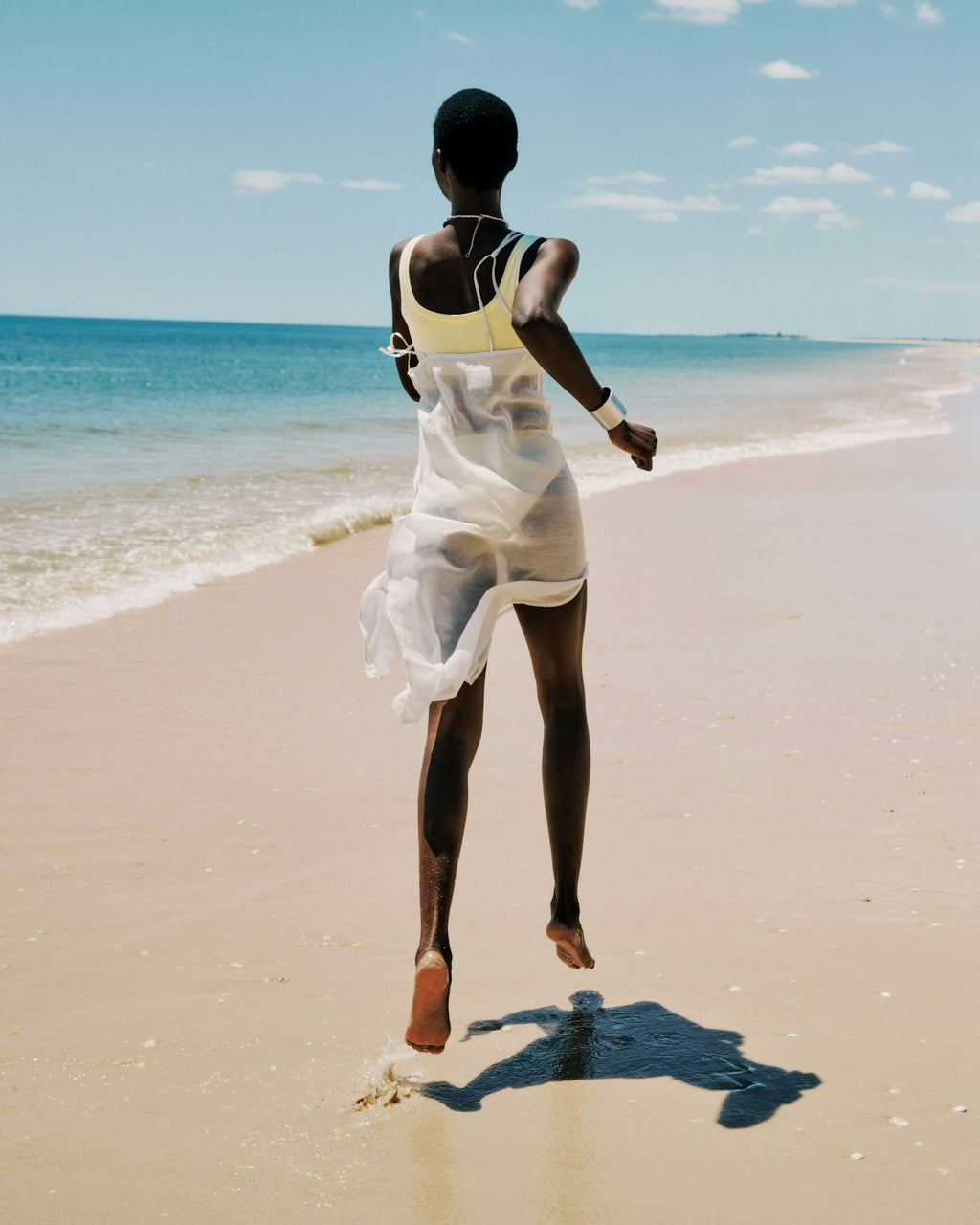 Person walking on a beach with ocean view