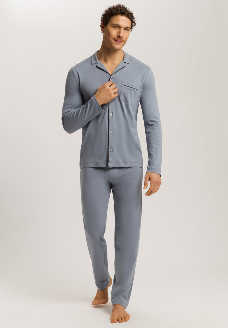 Man wearing a gray pajama set on a plain background