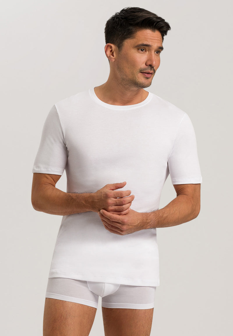 Man wearing a white t-shirt and underwear on a plain background
