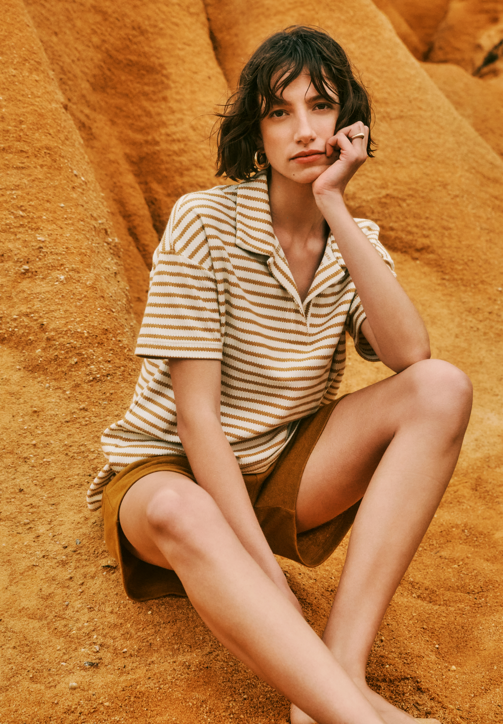 Women sitting on sand dune wearing Summer Knits Organic Cotton Collared Top in  Golden Cumin Stripe